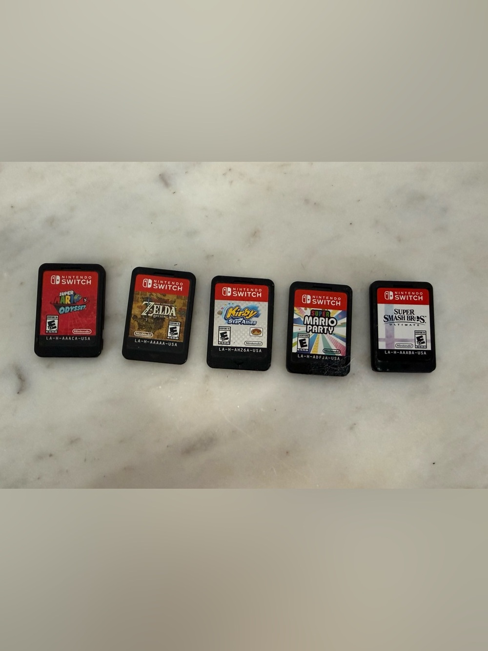 Nintendo Switch Lot 5 - Zelda Breath, Super Smash, Super Mario’s, Kirby